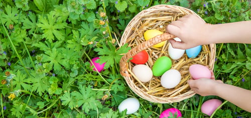 Preview: Krashenki homemade eggs in the basket and the hands of a child. Selective focus.