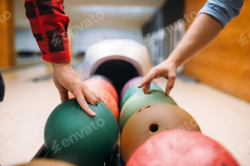 Preview: Two male bowlers takes balls from feeder