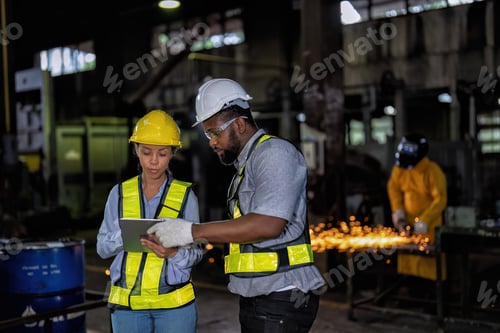 Preview: Maintenance engineer and manager in factory check part available repair machine near welder sparking