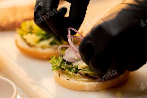 Preview: close-up professional kitchen in the hotel restaurant chef prepares the ingredients for the burger