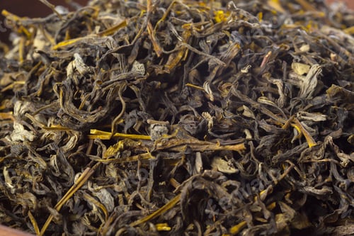Preview: Dry tea leaves on a surface showing detail in texture and color