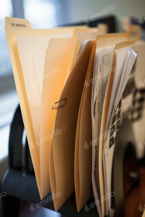 Preview: Close up of inbox row of files on office desk