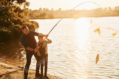 Preview: Some food to eat. Father and son on fishing together outdoors at summertime