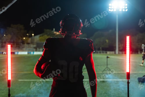 Preview: Football player entering stadium field at night