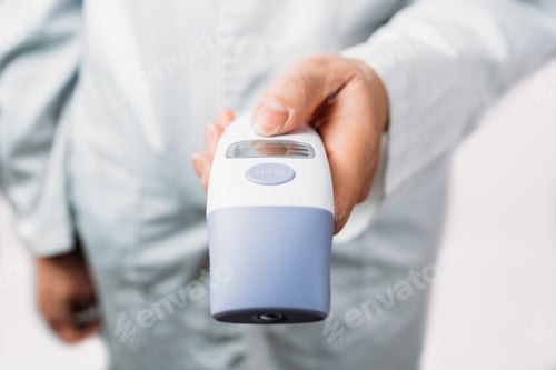 Preview: Shallow focus shot of a doctor checking temperature - new normal concept