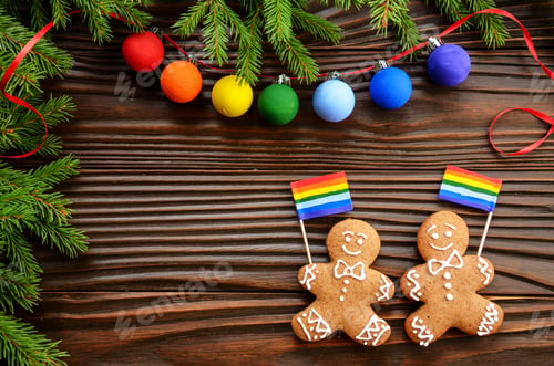 Preview: Christmas background of gingerbread man with flag spruce branches and colorful balls on wooden table
