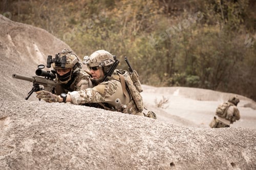 Preview: Soldiers aiming with their rifles
ready to fire during military operation