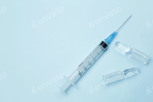 Preview: syringe and ampoules with medicine on a blue background