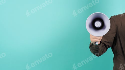 Preview: Hand is hold megaphone and wear navy color shirt on green or mint or Tiffany Blue background.