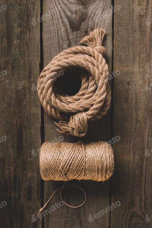 Preview: top view of two various beige ropes on wooden background