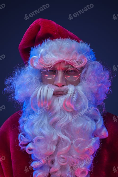 Preview: Santa claus with long beard and glasses staring at camera