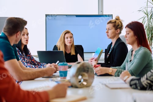 Preview: Diverse Business Team Discussing Projects in a Modern Glass Office.