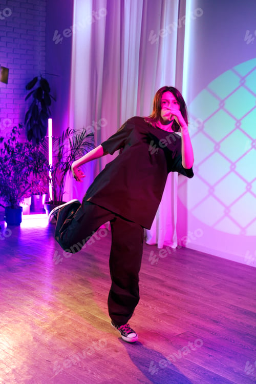Preview: Dance performance in a vibrant studio with colorful lighting and stylish attire