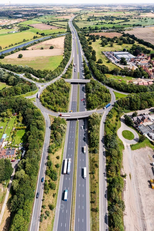 Preview: Aerial view above the M62 motorway with roundabout road junction
