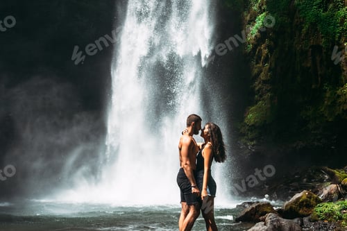 Preview: Beautiful couple kissing at the waterfall. A couple in love at a beautiful waterfall