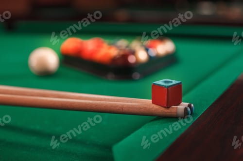 Preview: Cue and chalk on a pool table.