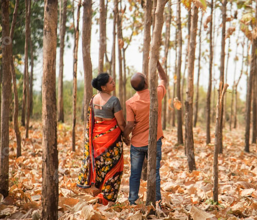Preview: Happy Indian senior couple walking in forest