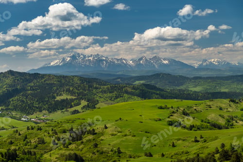 Preview: Green hills of Pieniny National Park and snowy Tatra Mountains in background in Poland