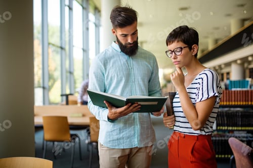 Preview: Happy group of success students studying and working together in a college library