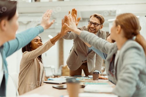 Preview: Young team putting hands up for new startup in the office