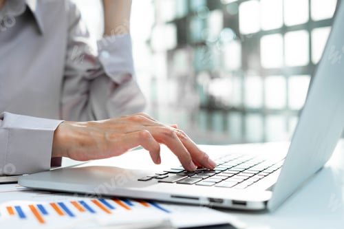 Preview: A close-up picture of a woman hand typing a message on the laptop keyboard Business women work in th