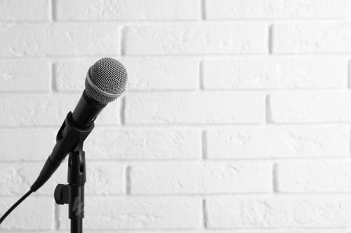 Preview: Modern microphone near brick wall. Space for text