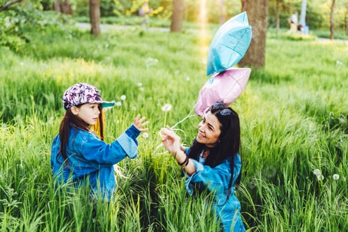 Preview: mom andbeautiful girl on the lawn