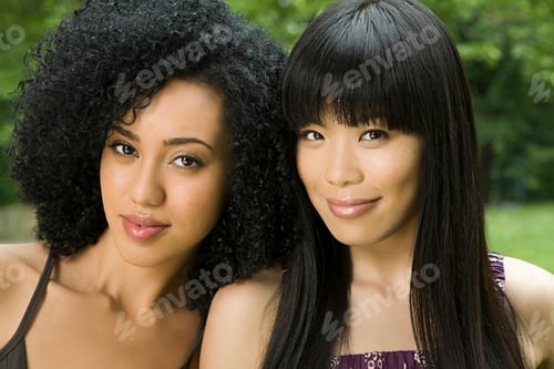 Preview: Two women smiling outdoors in a lush green park