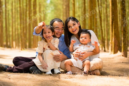 Preview: Smiling father and mother spending travel time with children at park