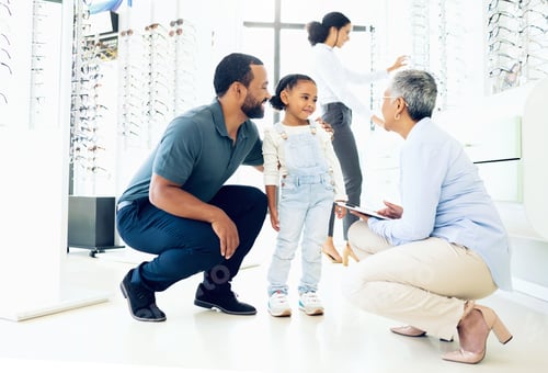 Preview: Optometrist, father and child for eye care, optometry or vision assessment or test in clinic or sto