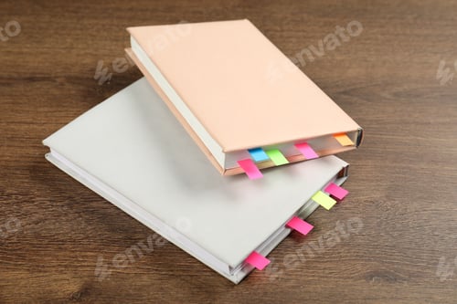 Preview: Books with colorful tabs on wooden table