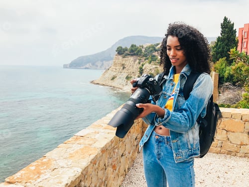 Preview: Photographer taking a picture of a ocean coast