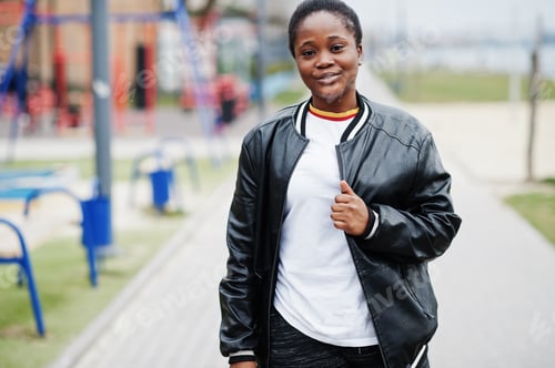 Preview: Young millennial african woman in city