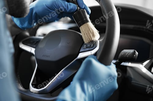 Preview: A man cleaning car interior, car detailing in Carwash service