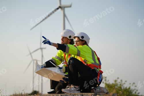 Preview: Sustainable energy industry - Engineers working at alternative renewable wind energy farm
