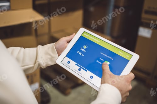 Preview: The young female owner and the man in the warehouse check the temperature, energy consumption and li