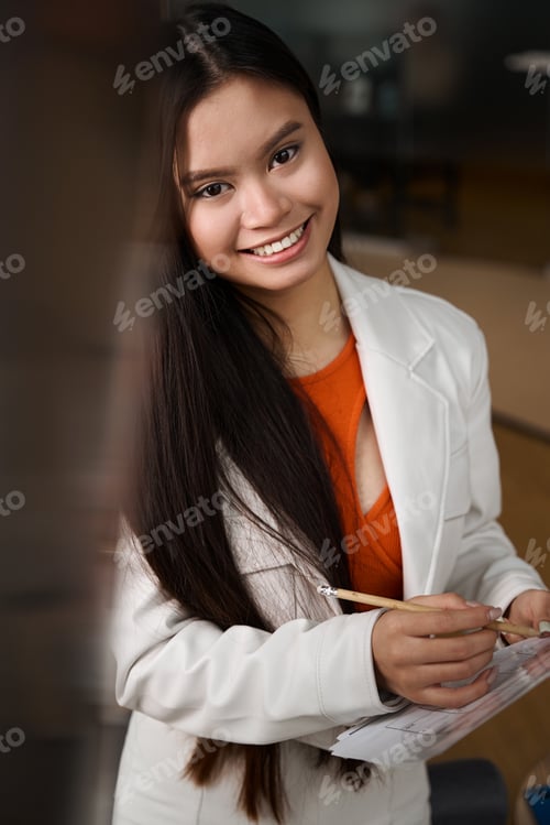 Preview: Joyful young office worker dealing with business documentation