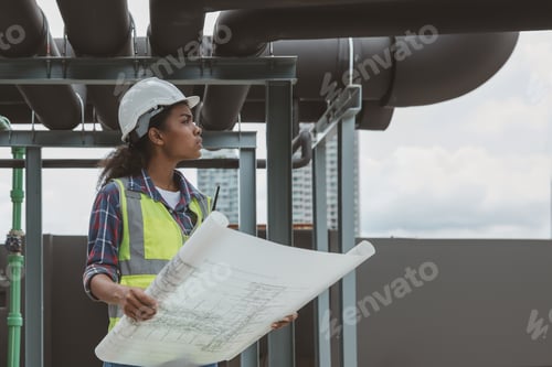 Preview: Engineers with draft plan of building on constructing site.