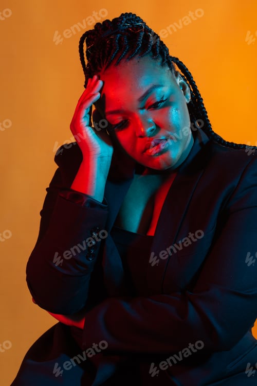 Preview: Portrait of beautiful young African American woman with afro and glamour makeup. Studio shot