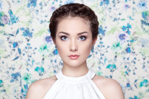 Preview: Portrait of young beautiful woman on a background of flowers