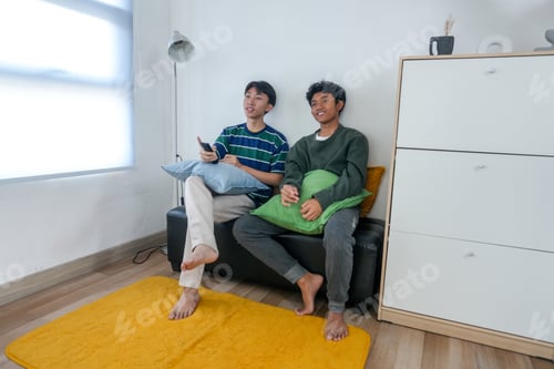 Preview: Two Young Friends Enjoy Relaxing Afternoon At Home Watching TV Together