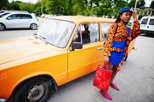 Preview: African american lady near orange classic retro car