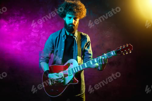 Preview: Intense Man Playing Electric Guitar on Stage