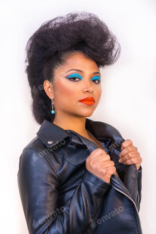 Preview: Closeup portrait of a fashion rocker style woman with bright makeup wearing a leather jacket
