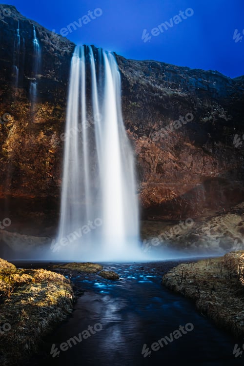 Preview: Vertical long exposure shot of a waterfall in Iceland