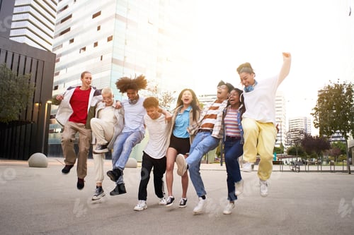 Preview: Carefree happy friends jumping in the street. Multiethnic group of young teenagers