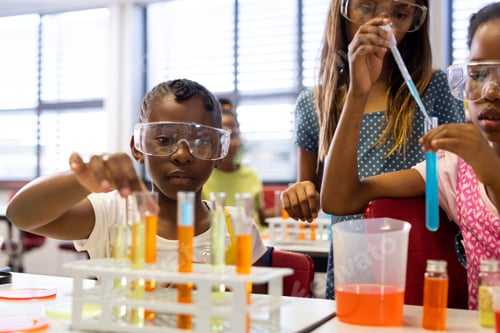 Preview: Diverse schoolgirls with chemistry items and liquids in elementary school class
