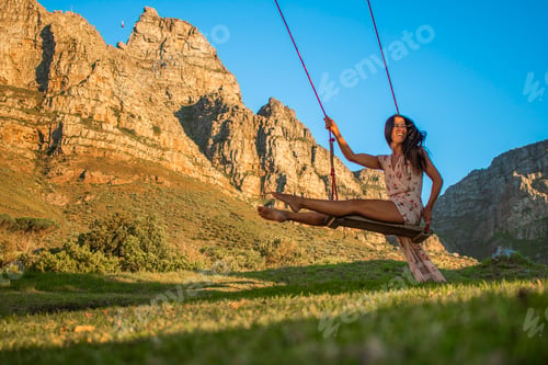 Preview: Woman on a swing in nature.