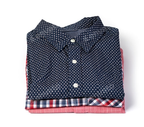 Preview: Folded Colorful Shirts Stacked Neatly on White Background