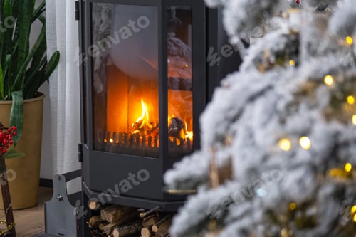 Preview: Metall black stove, burning hearth fireplace in white Festive interior of house is decorated for Chr